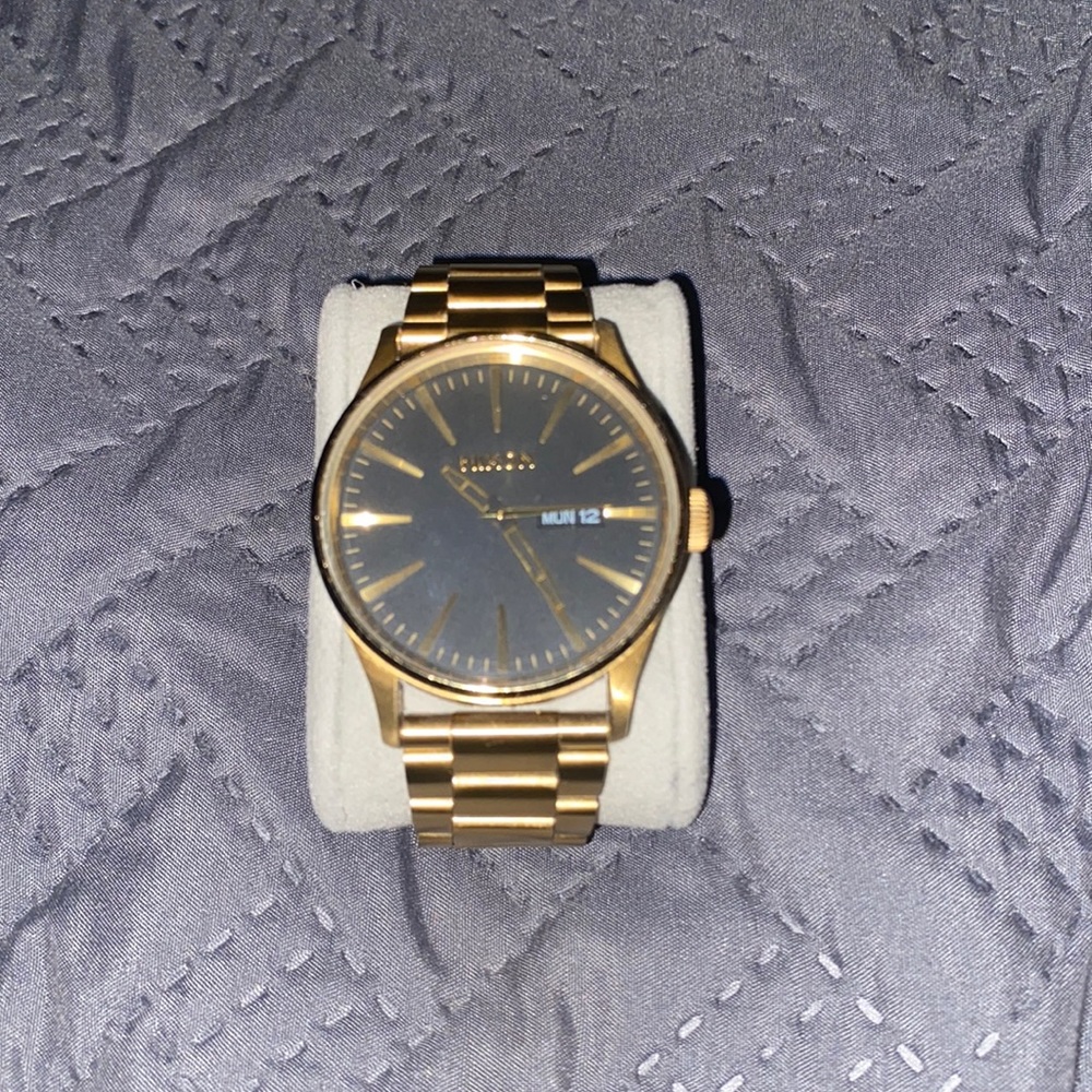 Men’s gold Nixon watch